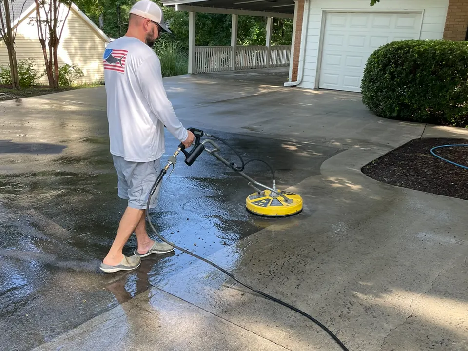 Cleaning a concrete driveway with a surface cleaner attachment