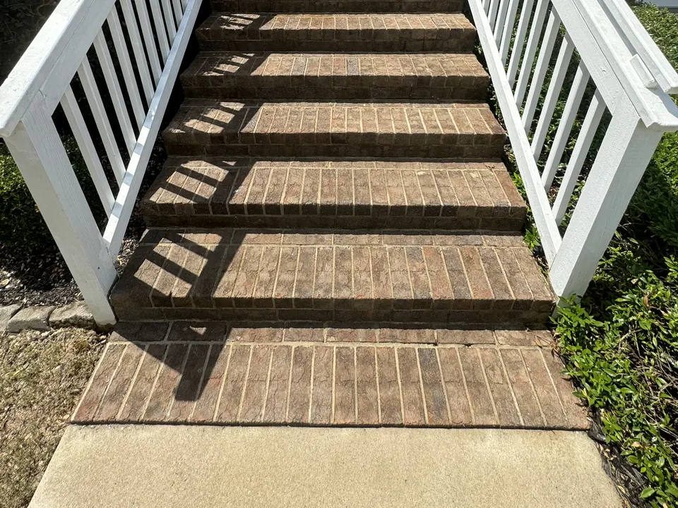 Brick front steps with white railings clean after cleaning