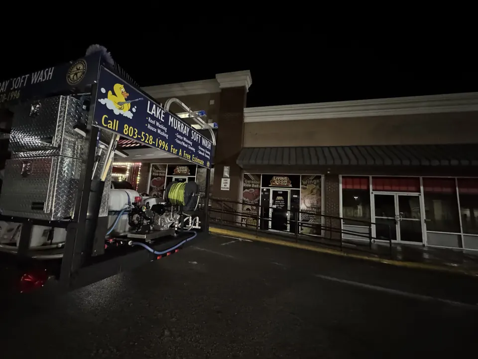 Lake Murray Soft Wash trailer beside a shopping center storefront at night
