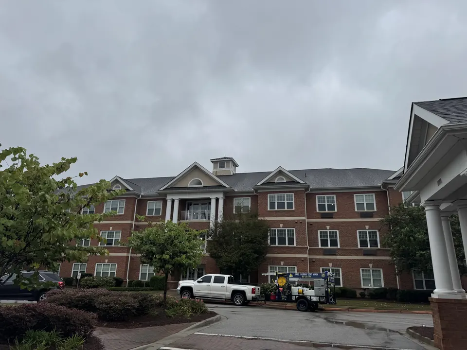 Large brick senior living building with the Lake Murray Soft Wash truck and trailer parked in front
