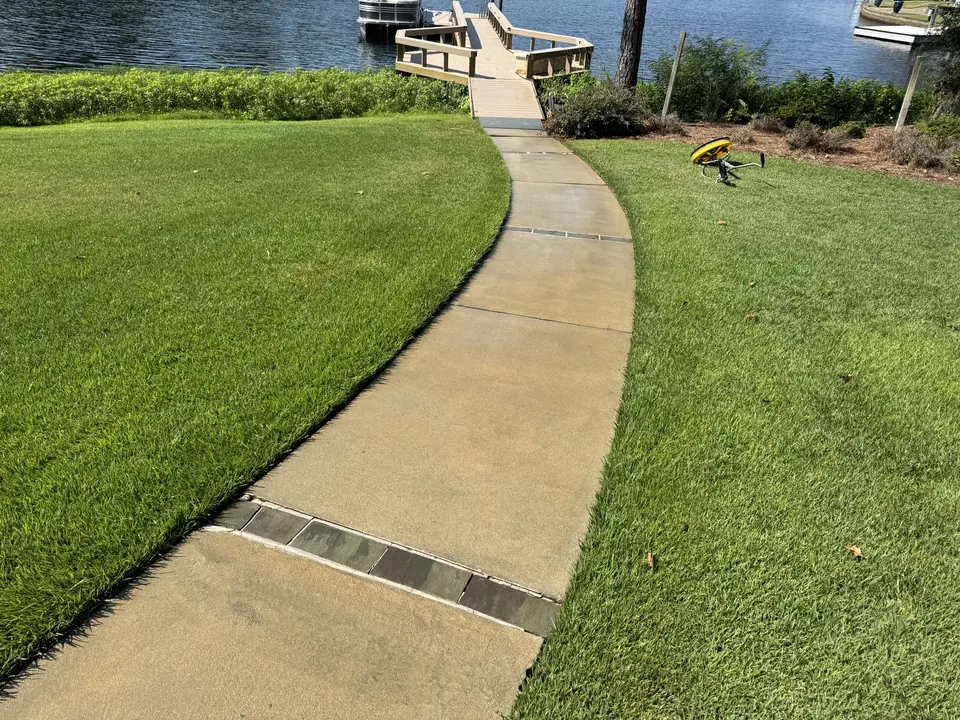 Clean concrete walkway to a lake dock after cleaning