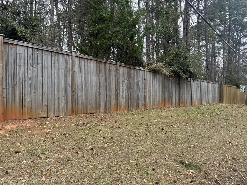 Gray, weathered wood privacy fence before cleaning