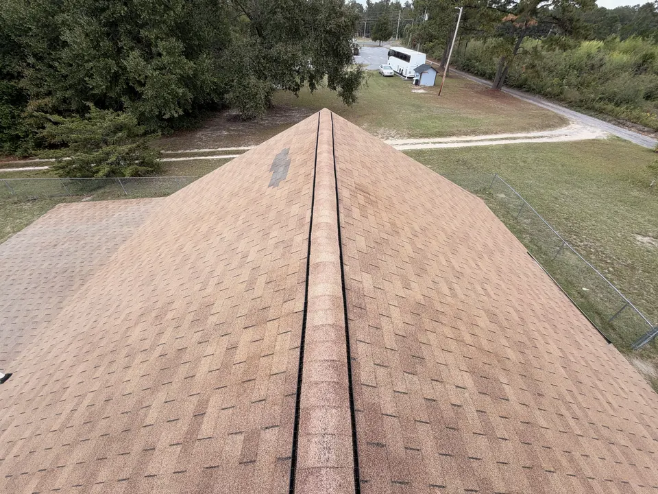 Same shingle roof after soft washing, with even color restored