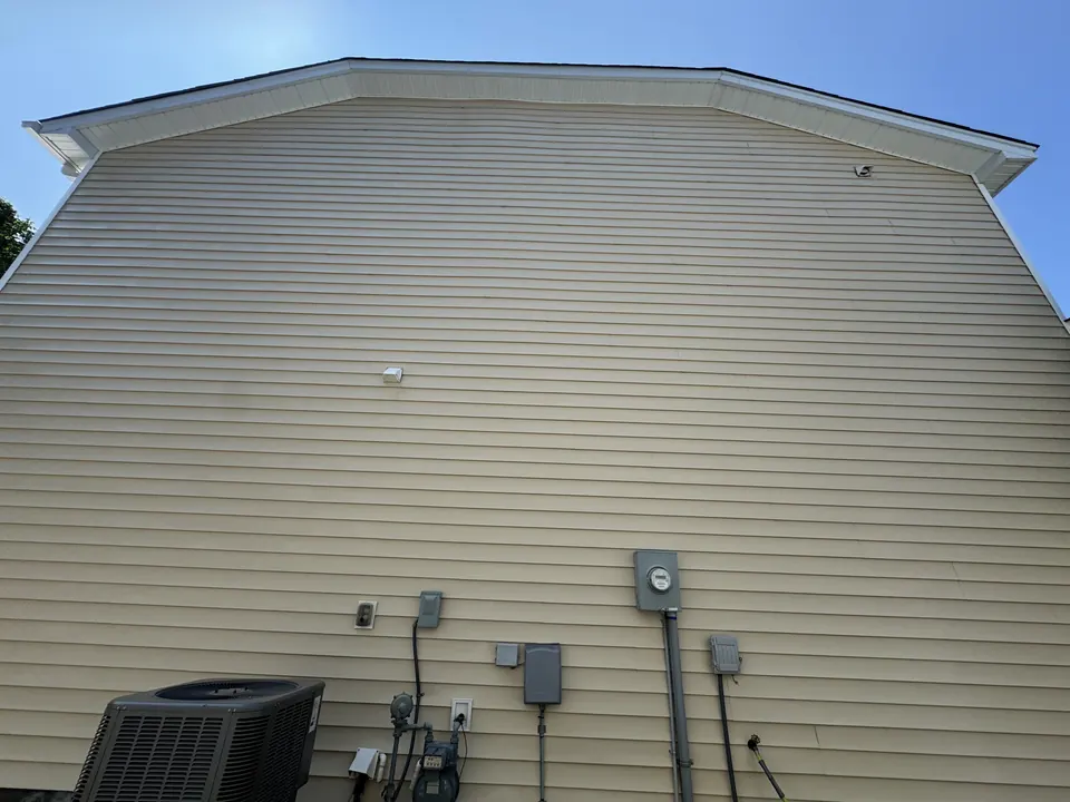 Same tan vinyl siding clean and bright after a soft wash