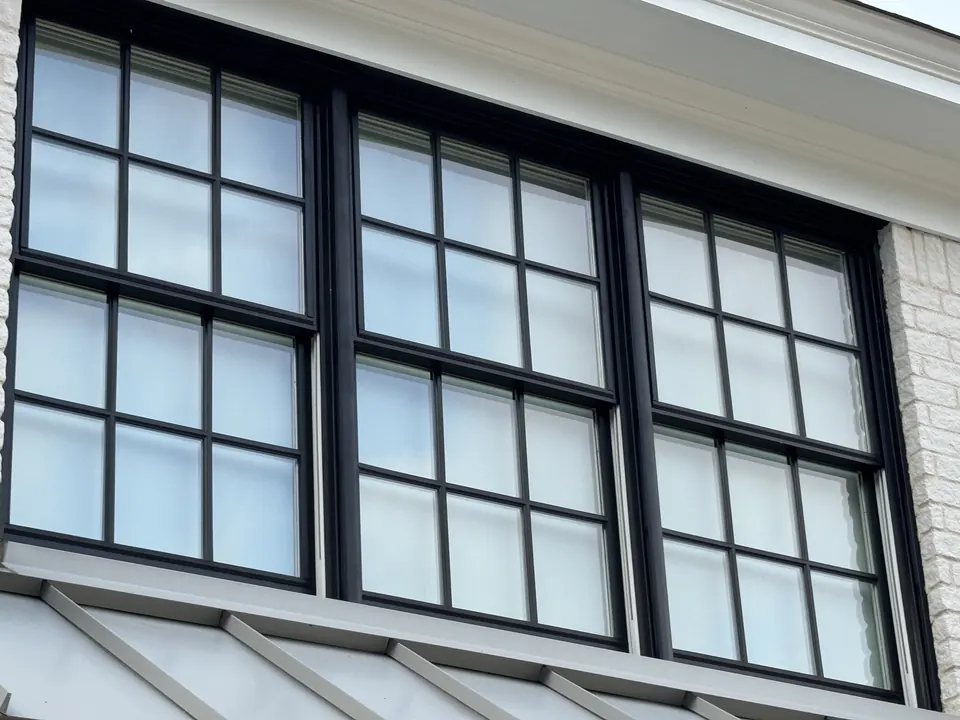 Large multi-pane windows with black frames, clean glass